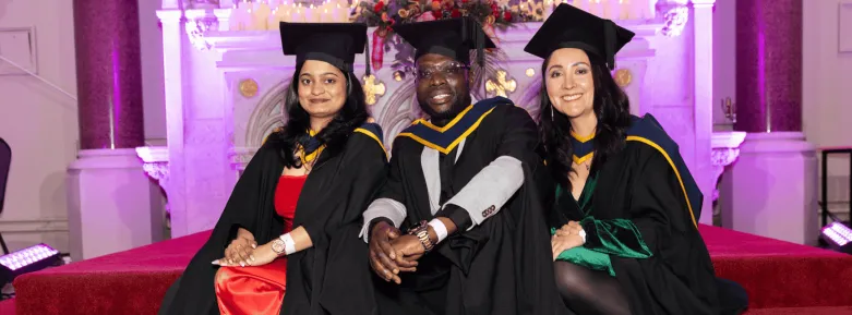 Three speakers on the altar at graduation