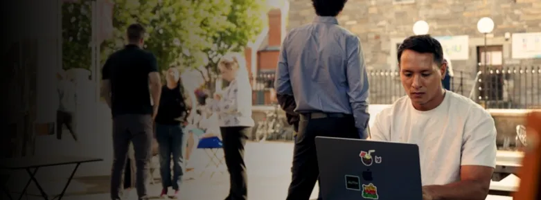 student working on laptop at bench