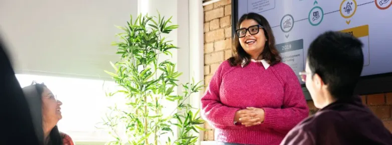 a woman standing in front of a window