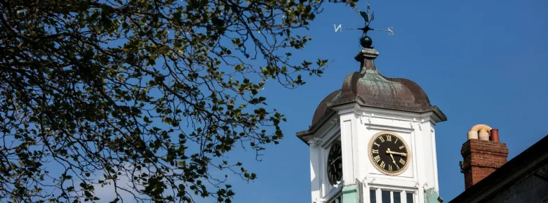 a large tall tower with a clock on the side of a building