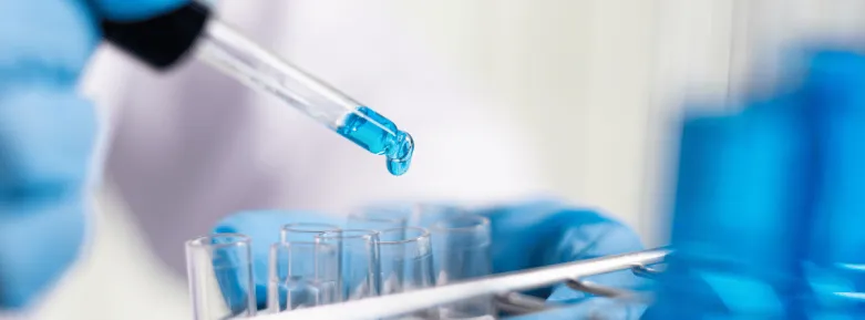 Dropper with blue liquid and clear test tubes