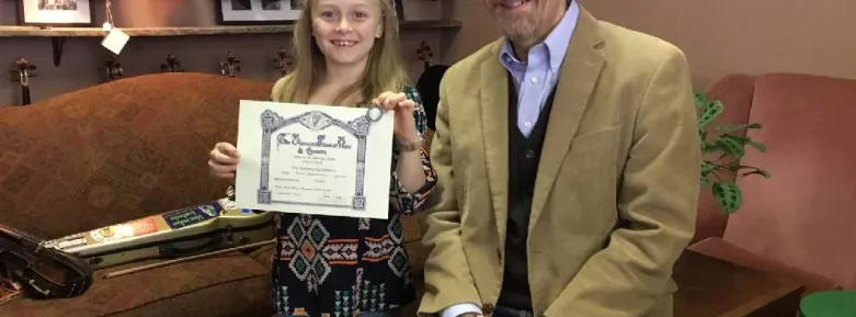 Abi Snell in 2019 with her music teacher and her Level 3 Certificate