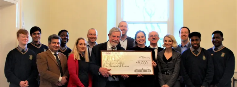 Professor Diarmuid Hegarty poses with staff members and representatives of the winning school, handing them a cheque for €5000