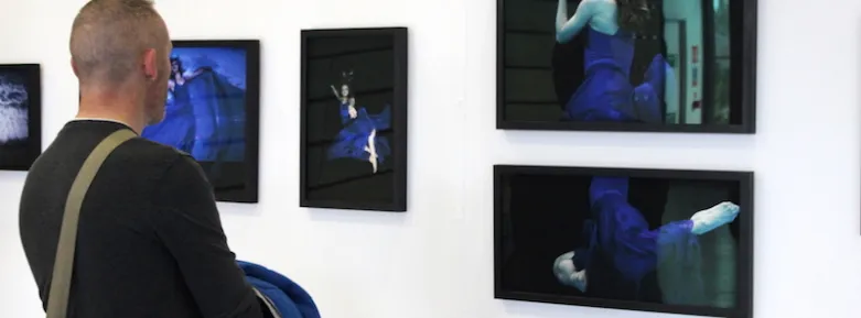 A man views one of the photography collections at the Griffith College Creative Show