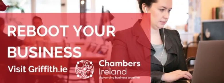 A woman using her laptop at a table to access the Chambers Ireland and Griffith College business planning course
