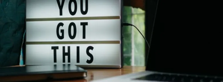 A desk lamp spelling out "You got this"