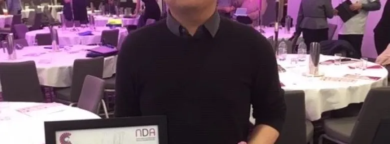 Griffith student Gerry Triyadi poses with his trophy and certificate at the Universal Design Awards