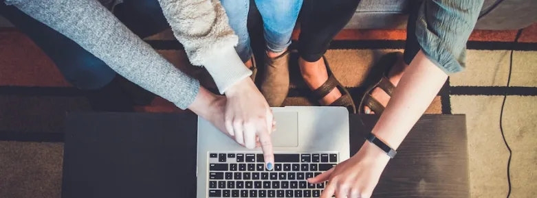 Birds-eye view of students working together at a laptop