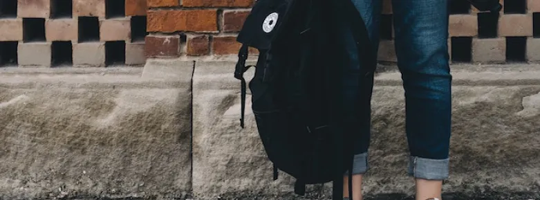 Student holding rucksack