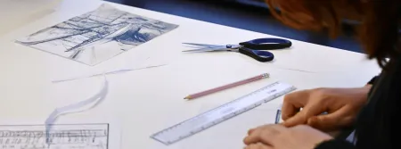 a person cutting a piece of paper