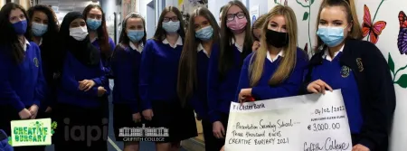 Students holding a giant cheque
