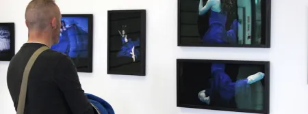 A man views one of the photography collections at the Griffith College Creative Show