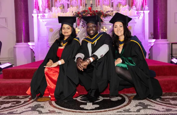 Three speakers on the altar at graduation