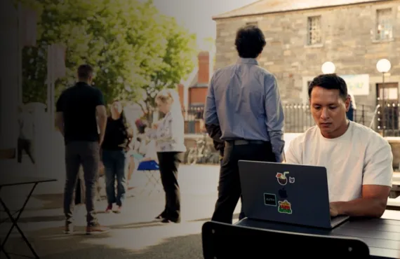 student working on laptop at bench