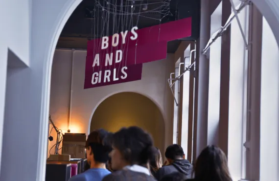 a group of people standing in front of a sign