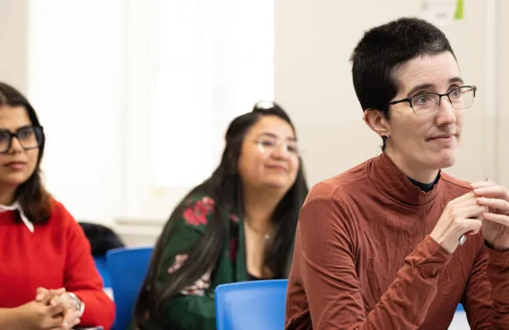 a man and a woman looking at a laptop