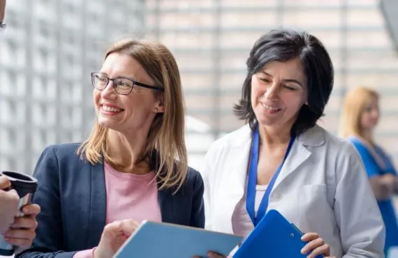 Three doctors discussing pharmaceutical sales