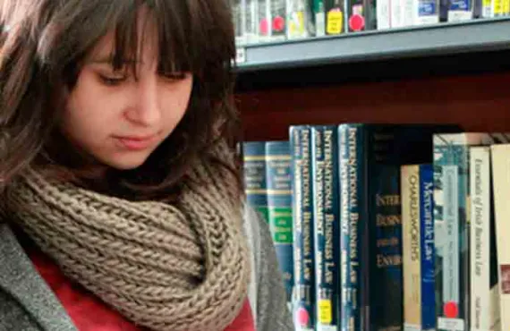 a woman holding a book shelf