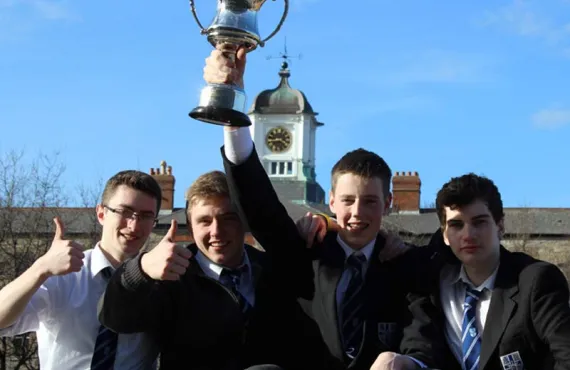 1st Place Business Enterprise Competition Winners Holds Cup Aloft