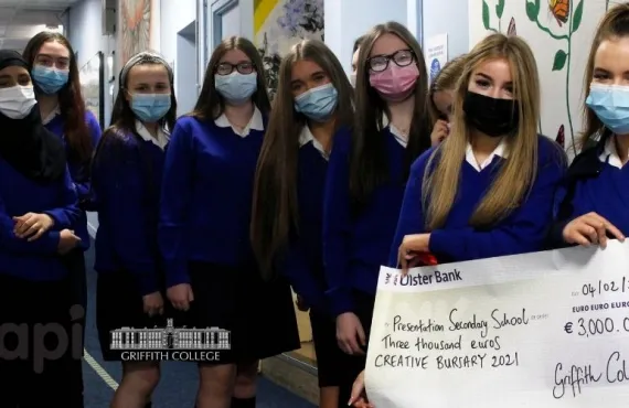 Students holding a giant cheque