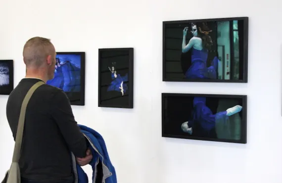 A man views one of the photography collections at the Griffith College Creative Show