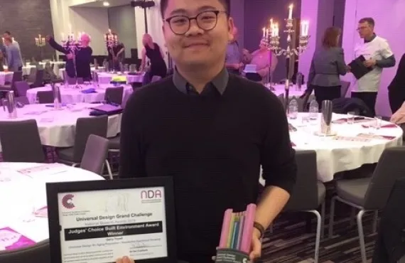 Griffith student Gerry Triyadi poses with his trophy and certificate at the Universal Design Awards