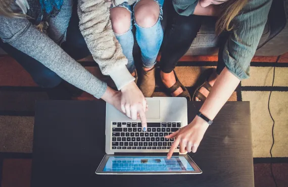 Birds-eye view of students working together at a laptop