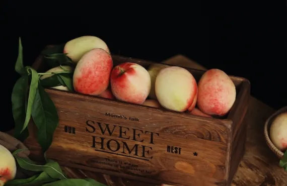 A box of fruit against a dark background