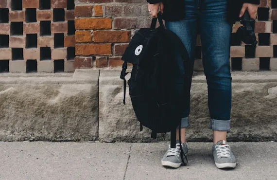 Student holding rucksack