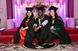 Three speakers on the altar at graduation