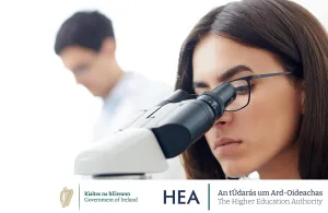  a woman looking through a microscope
