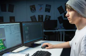 a man standing in front of a computer