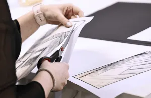 a person cutting a piece of paper