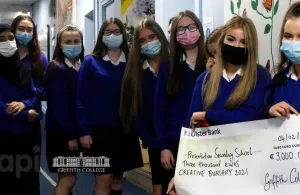 Students holding a giant cheque