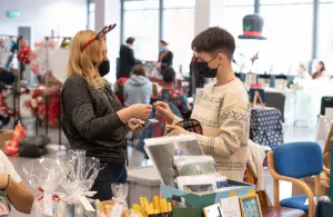Two people making a purchase at a christmas market