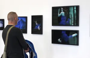 A man views one of the photography collections at the Griffith College Creative Show