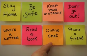 Sticky notes with reminders for the COVID-19 world like "be safe" and "stay home"