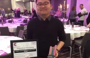 Griffith student Gerry Triyadi poses with his trophy and certificate at the Universal Design Awards