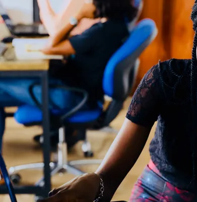a man sitting at a table using a laptop