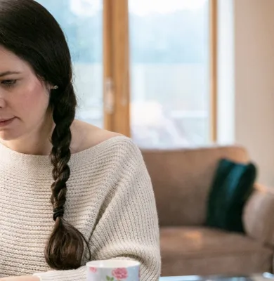 a woman sitting at a table in front of a window