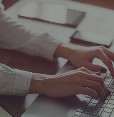 a person using a laptop computer sitting on top of a table