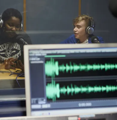 a person sitting at a desk in front of a computer