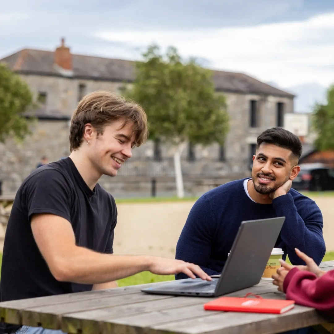 Students smiling outside