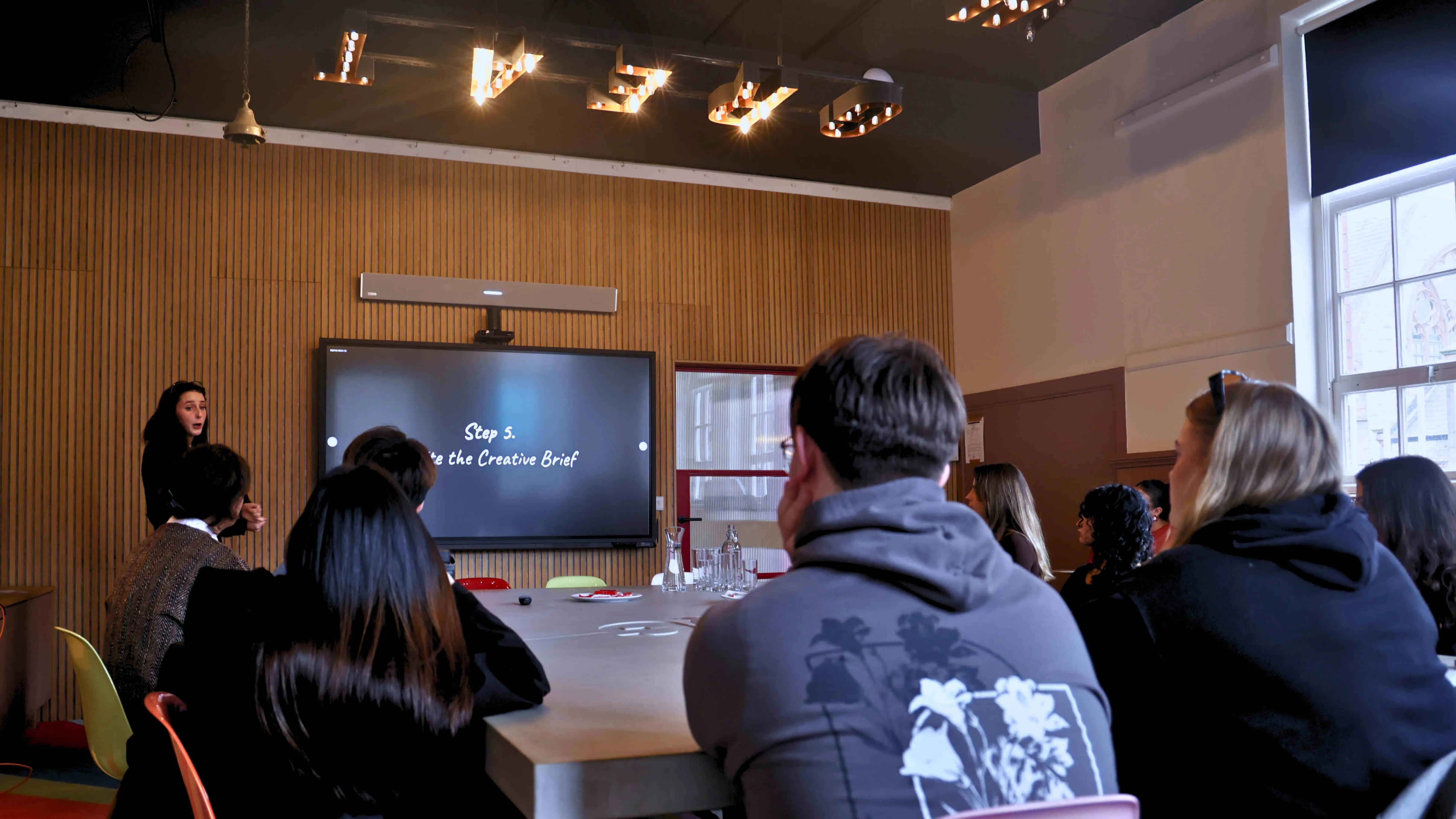 students sitting and listening to a presentation