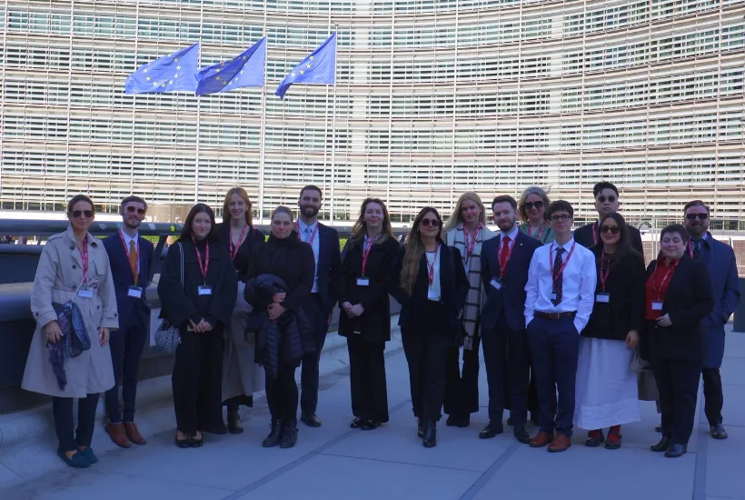 a group of people standing in front of a crowd posing for the camera
