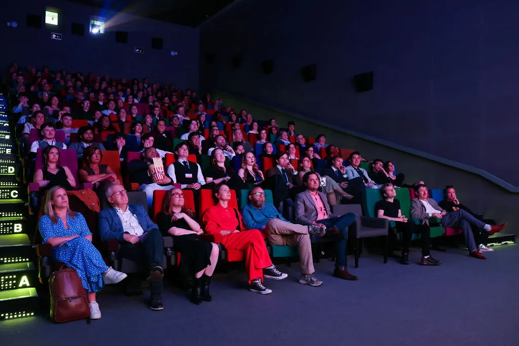 a group of people sitting in front of a crowd