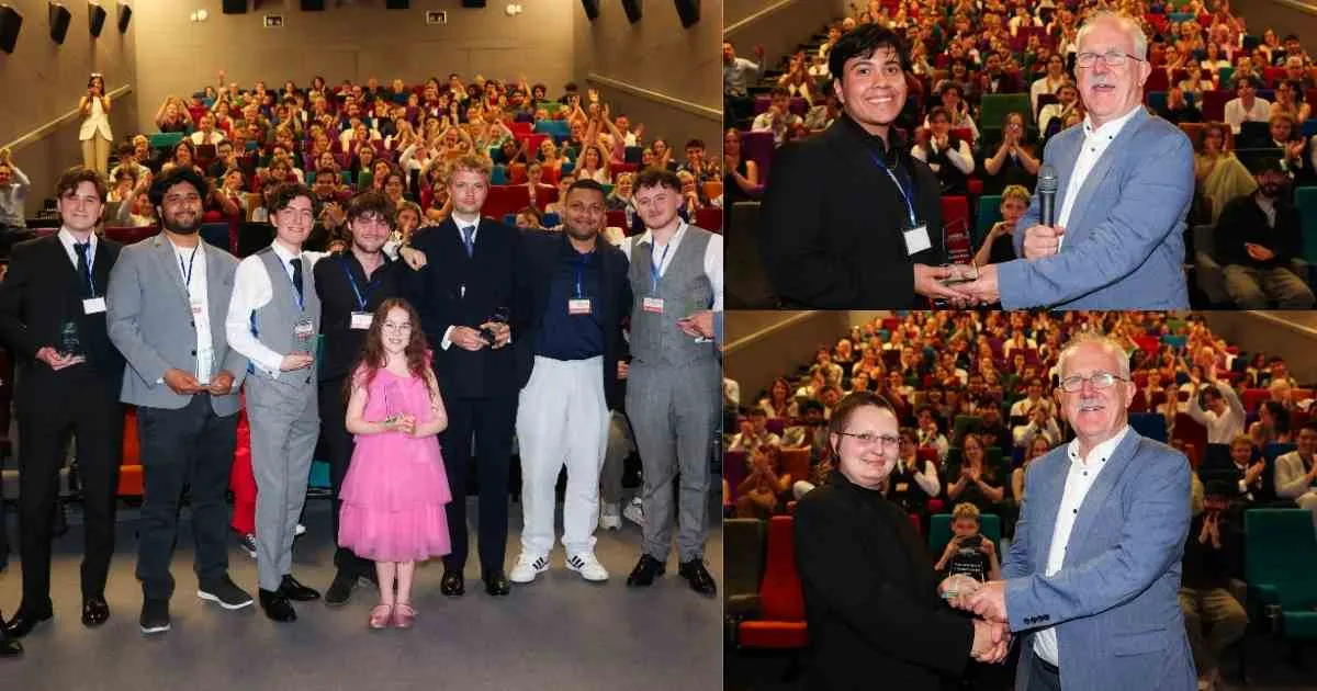 a group of people standing in front of a crowd posing for the camera