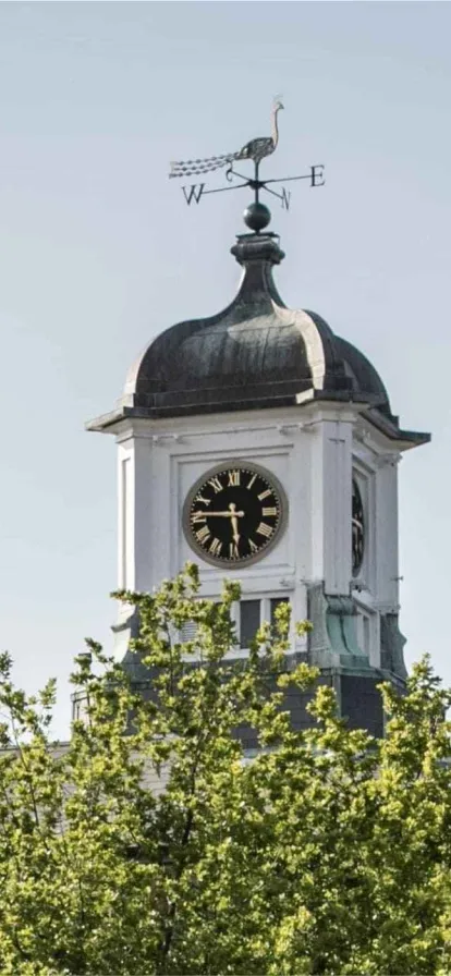 a clock tower in front of a building