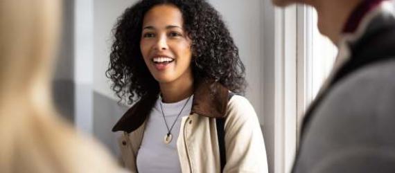 a learner smiling in a room