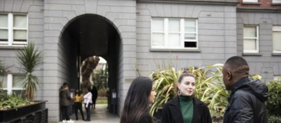 learners standing in front of a building